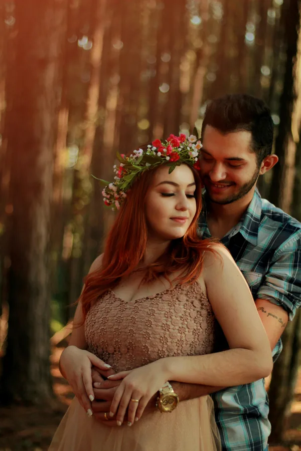 Couple romantique enlacé dans une forêt au coucher du soleil