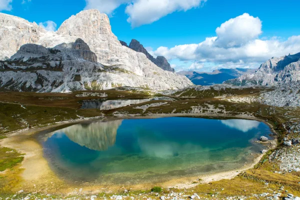 Lac de montagne cristallin au pied de sommets rocheux majestueux